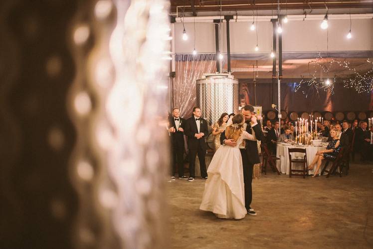 A wedding at a local winery calls for natural elements including vintage lighting
