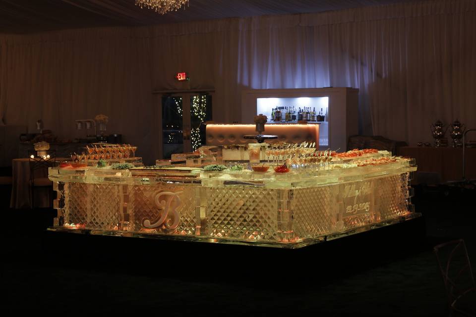 Custom 4-sided raw bar completely made from ice with a sushi station, ceviche station, and three types of oysters.