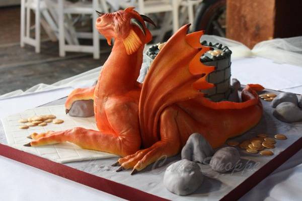 Hand sculpted dragon groom's cake