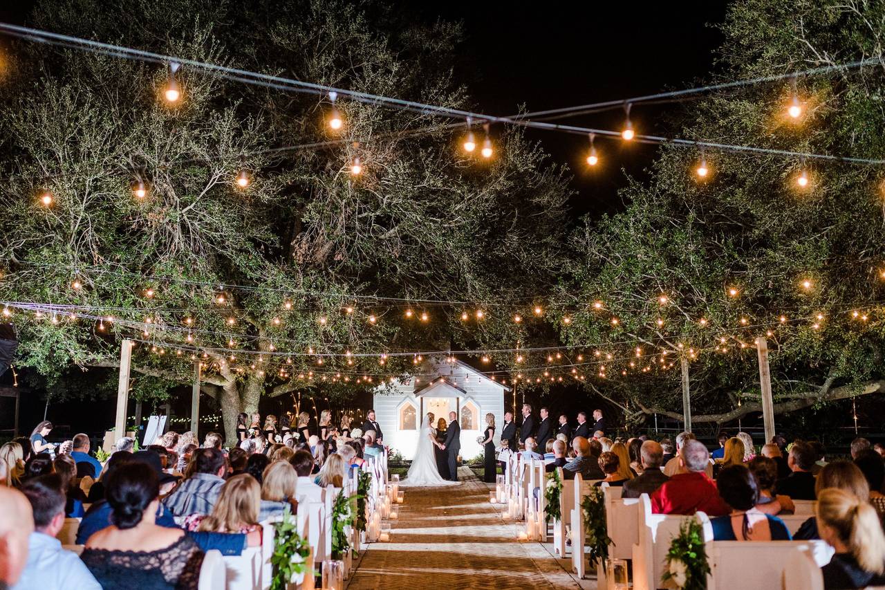 Greenery hanging in the tent at Green Acres with chandeliers and