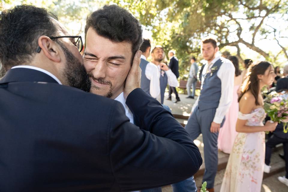 Groom gets a kiss from his dad