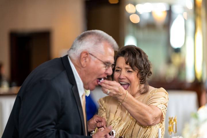 Bride feeds the groom wedding cake