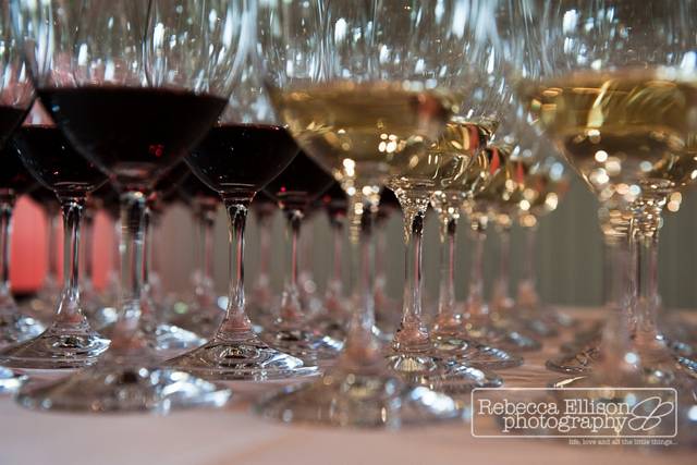 Wine at the beginning of a reception ready for the guests exiting the ceremony.