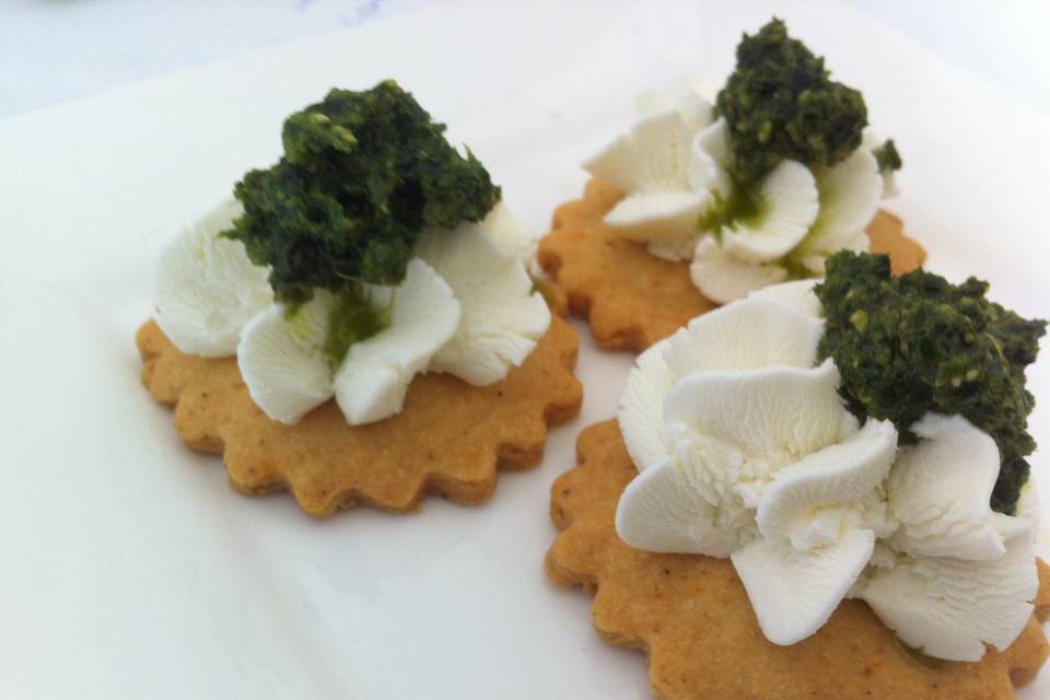 Pesto and goat cheese canapé on jalapeno parmesan shortbread cracker