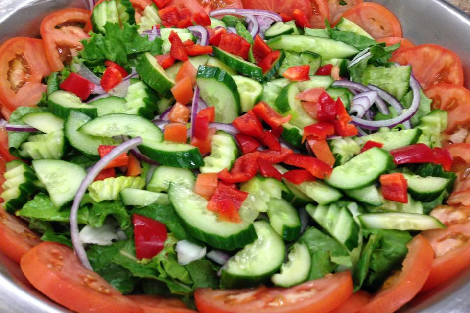 Buffet salad with cucumbers, red bell peppers and tomatoes www.aristacatering.com