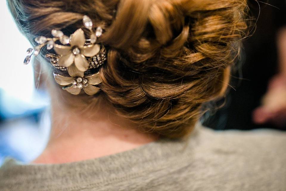 Curled low bun with gold flower ornament