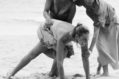 girls having fun at a beach wedding