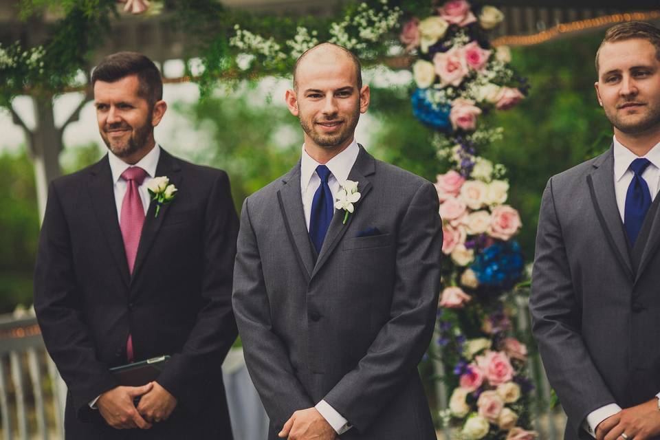 Officiant, groom and groomsman