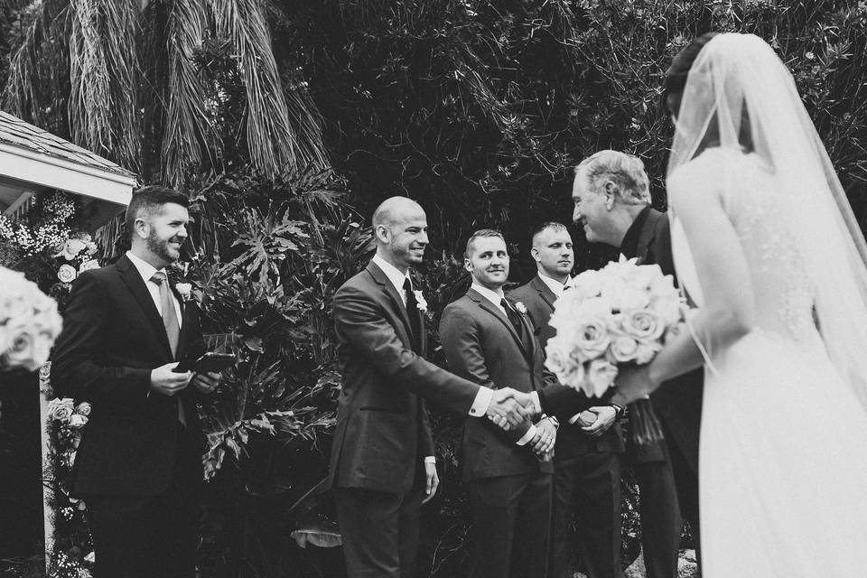 Groom and bride's father shaking hands