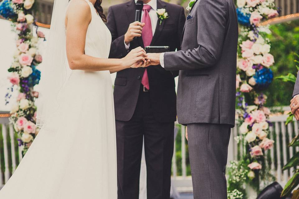 Bride putting a ring on the groom