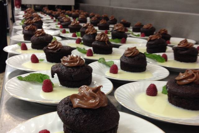 Godiva chocolate cake with chocolate buttercream frosting and a white Godiva chocolate sauce