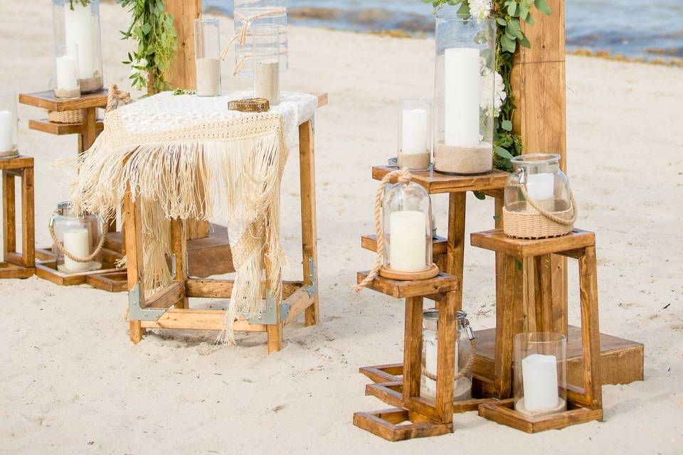 Modern beach wedding featuring our Valerie Structure and rustic pedestal trios