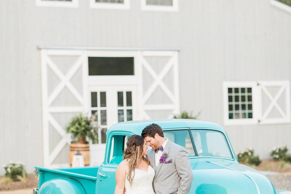 The Establishment Barn - newlyweds with vintage car