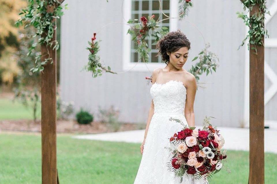 The Establishment Barn - bride under wedding arbor