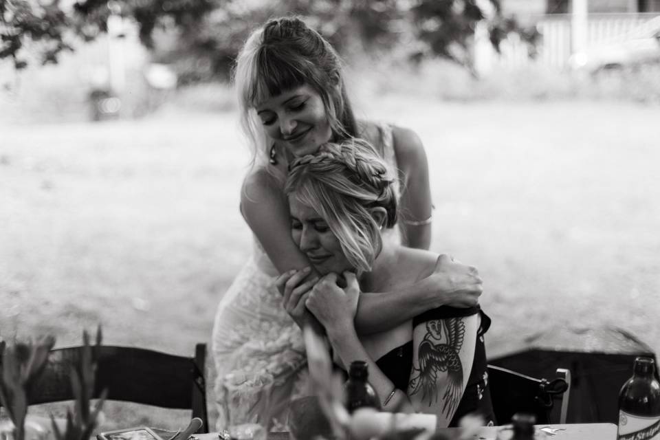 Sisters hugging on wedding day