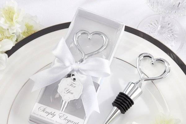 This is the perfect party favor! Give your guests a piece of your heart with this fabulous Heart Bottle Stopper. Along with the graceful chrome heart that sits atop the bottle stopper, the lovely wedding-white gift presentation speaks for itself.  Advantage Bridal is pleased to offer fast shipping and a low price guarantee on all of their products.
More Details about these favors:
•A chrome heart design tops this meaningful bottle stopper
•Bottle stopper is 4 1/2