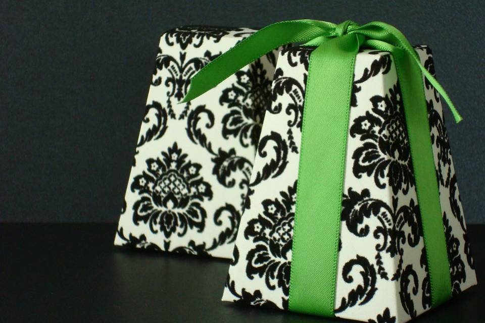 Stay on top of the hottest trend in favors.  This season, Damask is still a big trend in the wedding industry and brides are looking for more new and unique ways to incorporate it. Our Damask favor boxes bring a modern and colorful twist to the classic print! These black flocked favor boxes are a delightful way to package treats or other small surprise for a wedding, bridal or baby shower, or other special event.
Ribbon is not included. Each box is made from a medium weight (65 lb) cardstock.
The inside of each box features a black dot pattern.
Box measures 2 1/2
