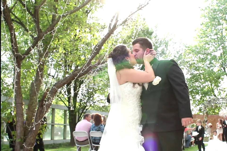 Chelsey and Steve share their first post-wedding kiss right at the end of the aisle!