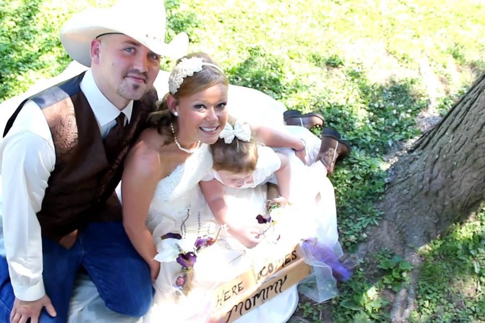 Katti and Nathan pose with their little daughter holding her 