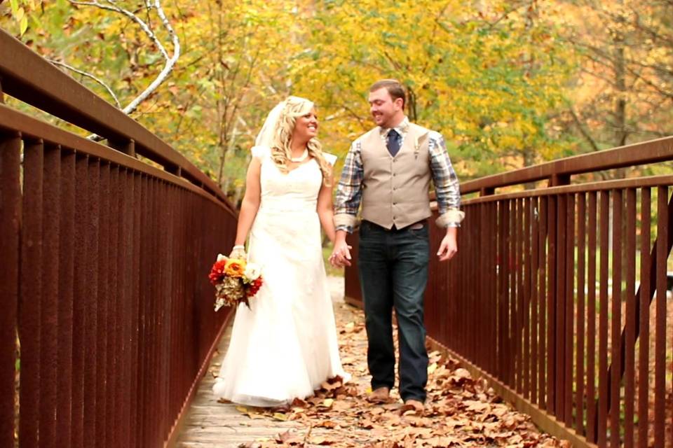 Leslie and Patrick walk hand in hand across the Lake Vesuvius bridge.