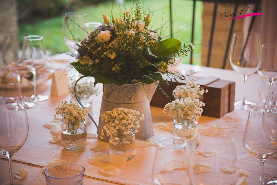 Centerpiece with wildflowers and candles for a magical country atmosphere