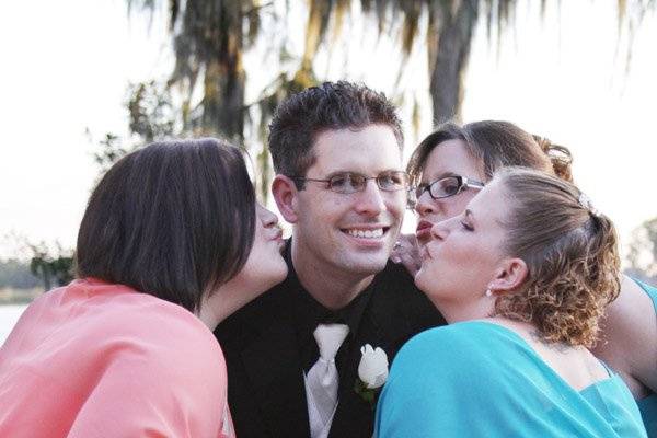 Bridesmaids Kissing Groom