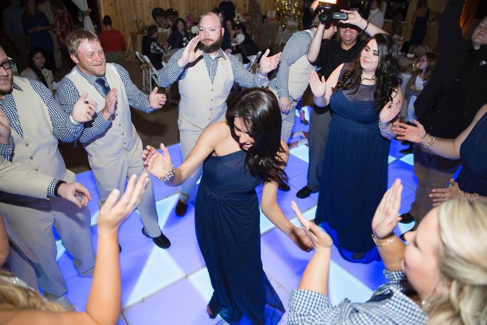 Dance circles are so fun. Keep your guests on the dance floor with the perfect DJ and an awesome dance floor! Photo by Melissa Albey Photography