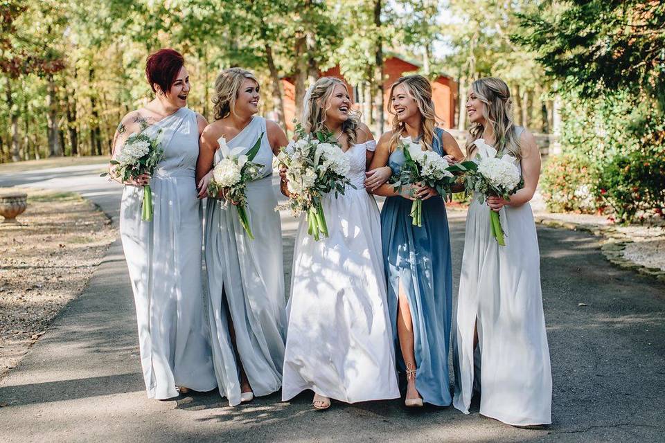 The bridesmaids share a laugh outside of The Homestead. Photo by Embers Night Photography.