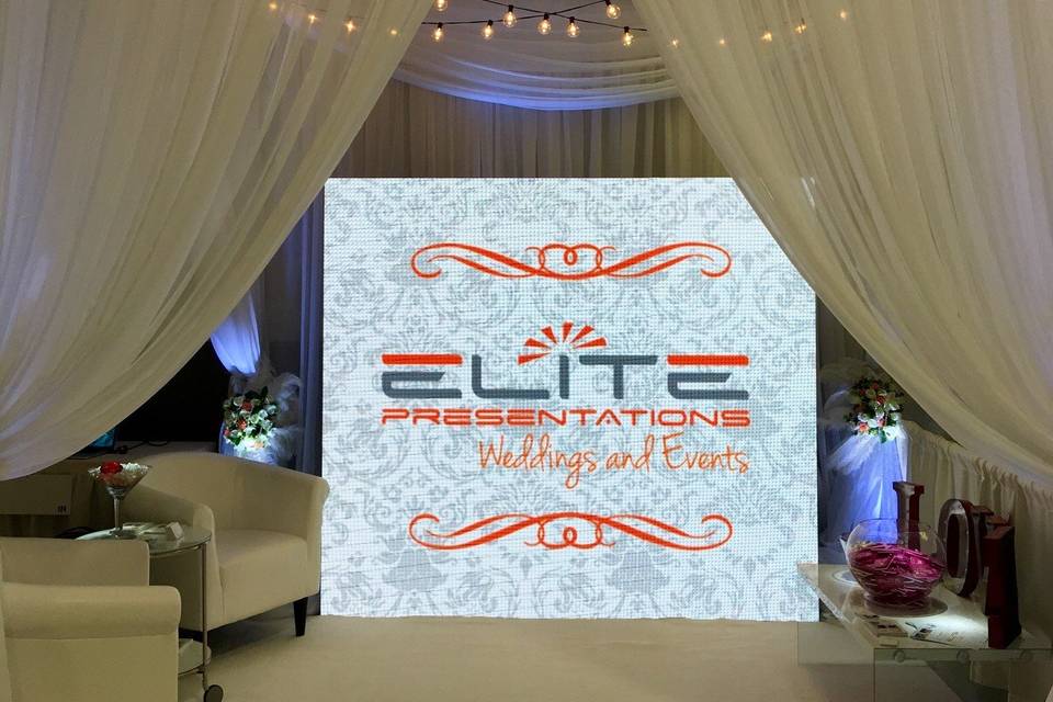 Uniquely Yours Bridal Show Booth Displaying LED Video Wall, Draped Canopy, Uplighting, Pinspotting, Bistro Lighting and Special Decor