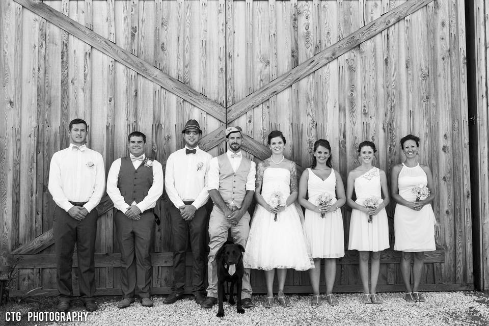 Black and White Vintage Shot of Bridal Party in front of Historic Barn