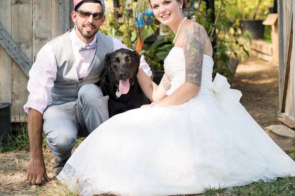 Bride, Groom and Their Dog in front of Atrium Greenhouse