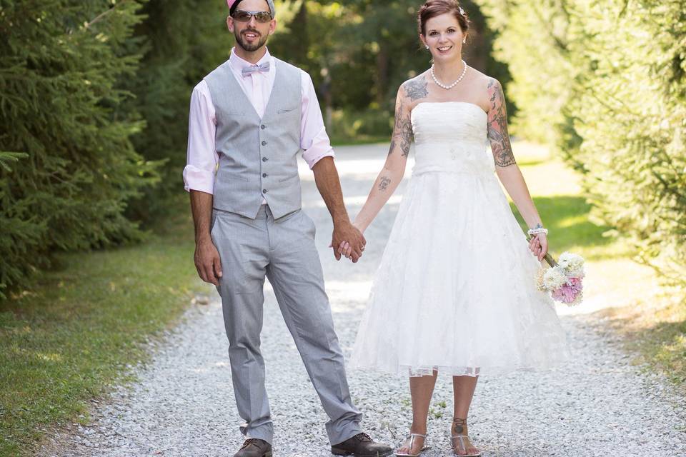 Bride and Groom amongst Farmhouse Pine Tree lined driveway