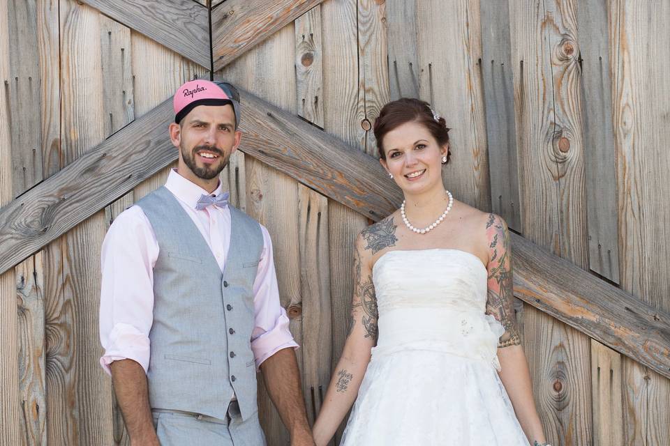 Husband and Wife in front of Historic Barn Doors