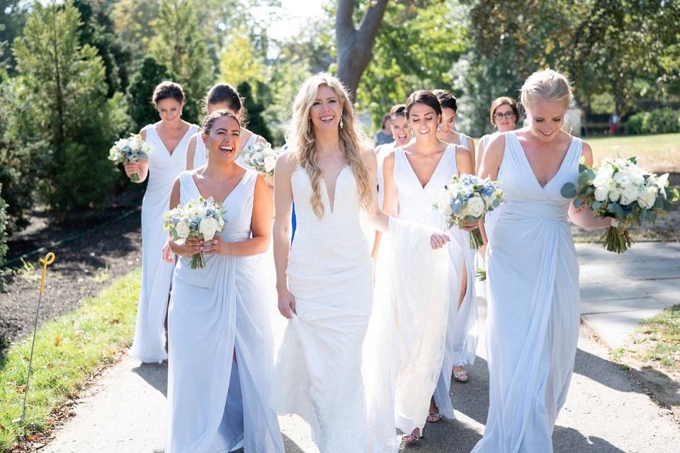 Smiling bride walking with bridesmaids