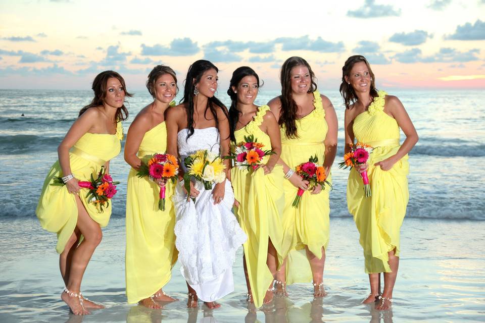 Bride and her bridesmaids by the beach