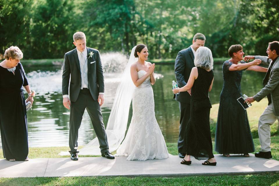Newlyweds and their guests by the water