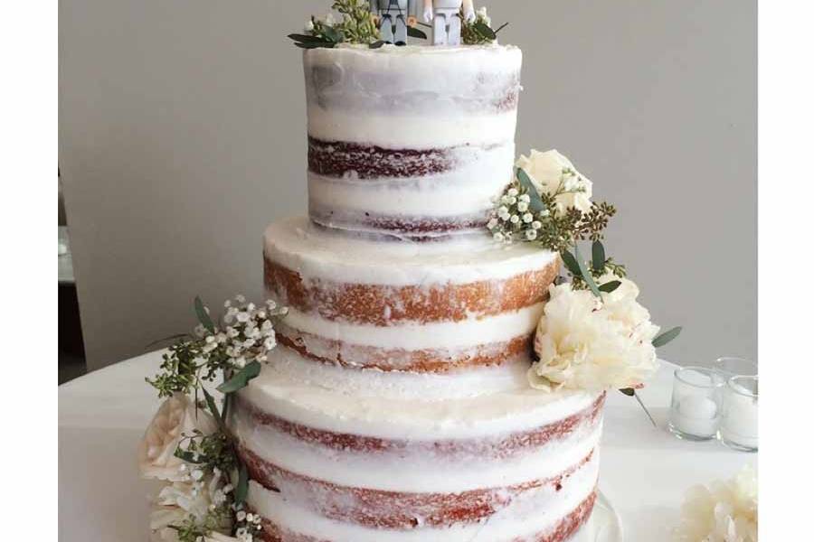 Naked wedding cake with bride and groom topper