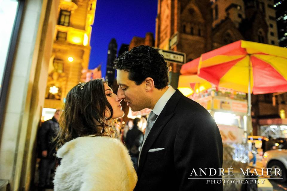 bride and groom kiss outside the St Regis Hotel NYC