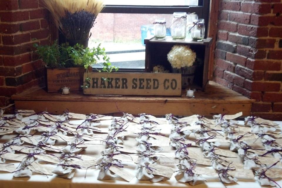 Escort card table. Favors designed and created by family. Tablescape design by Lady Slipper Affairs & Events.