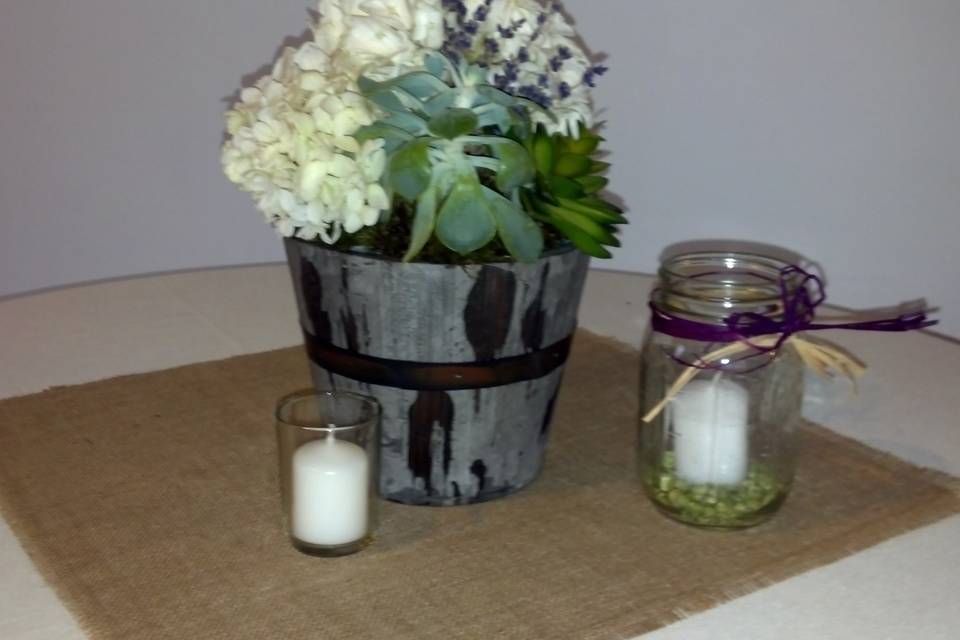 Cocktail area high top flower arrangements. Hydrangea, succulents, lavender and mood moss. Design Lady SlipperAffairs & Events .