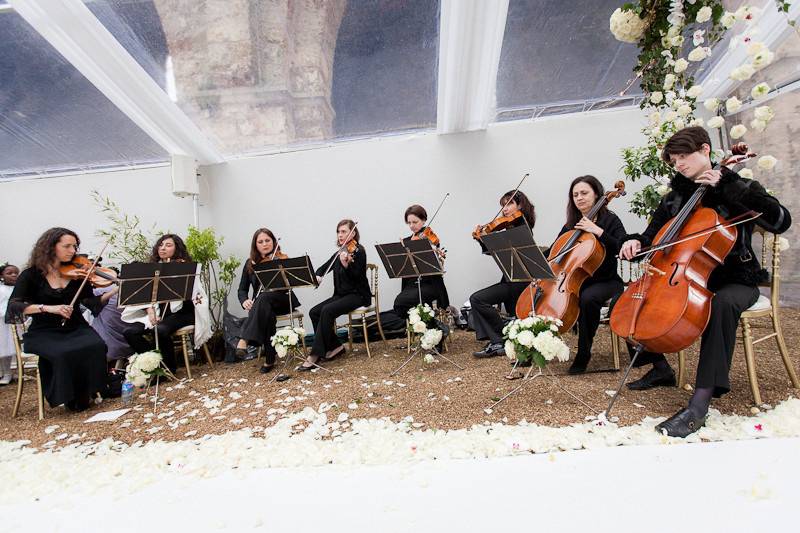 The string orchestra of Wedding Music in France playing in an old Abbey outside of Paris