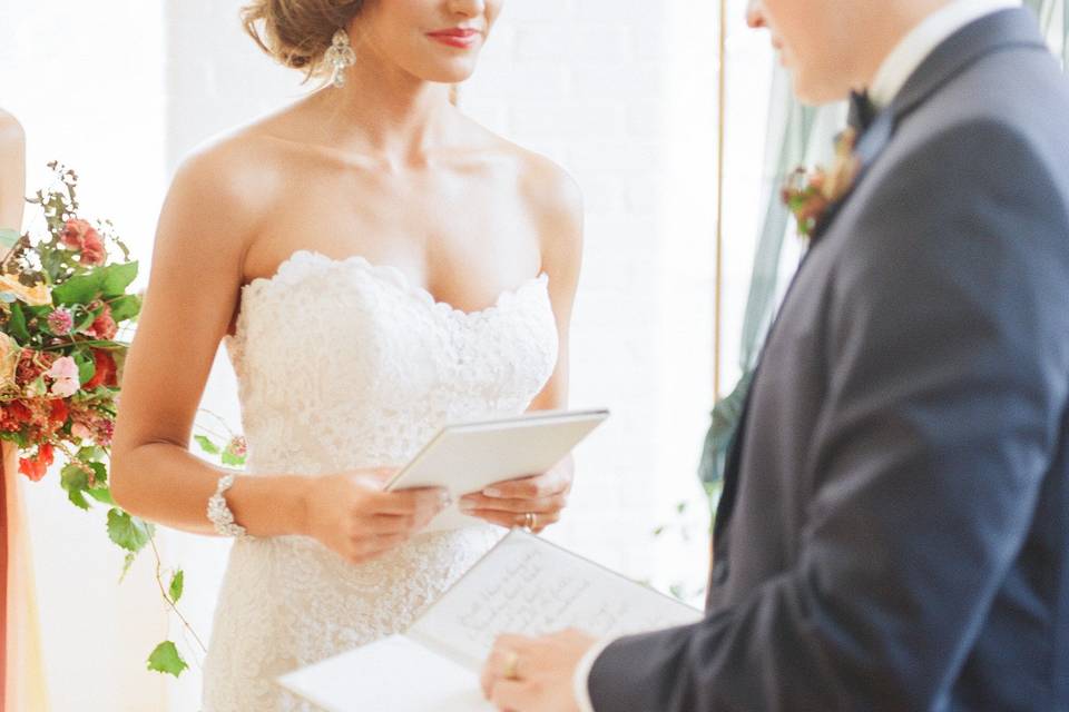 Couple holding vow books