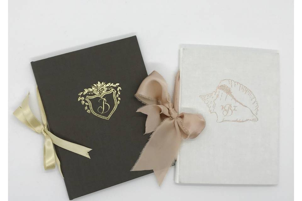 Custom vow books with monogrammed crest