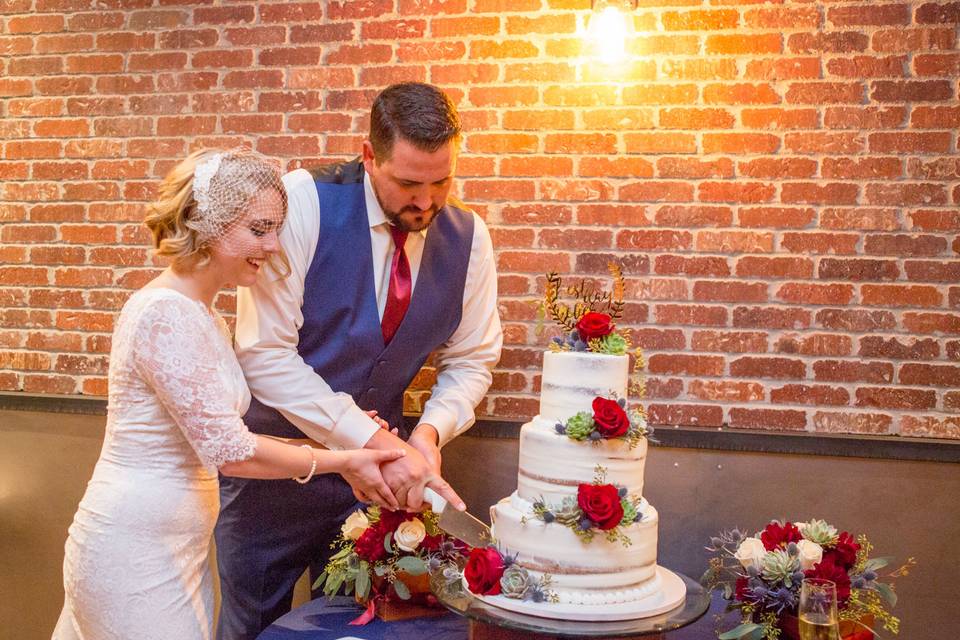 Cutting into their beautiful wedding cake  (Photo by: NVS Photography)