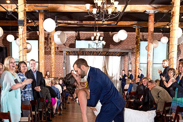 Some couples walk down the aisle after the wedding and some run.  These two newlyweds decided to put their own spin on it with a preview of their dance moves.