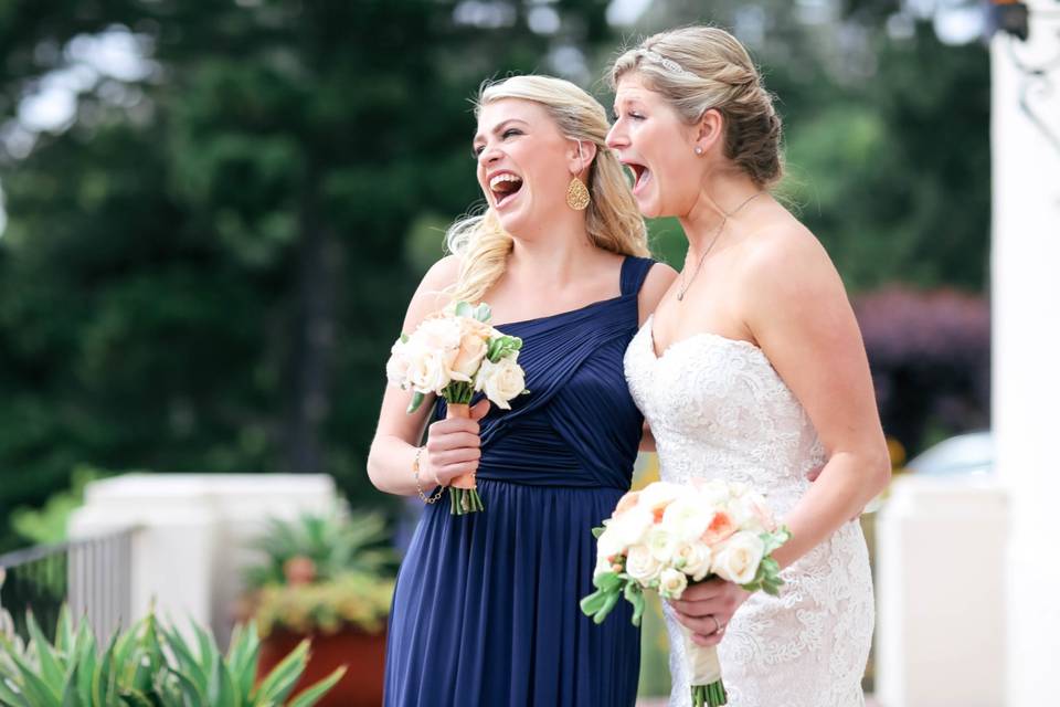 Bride and bridesmaid laughing