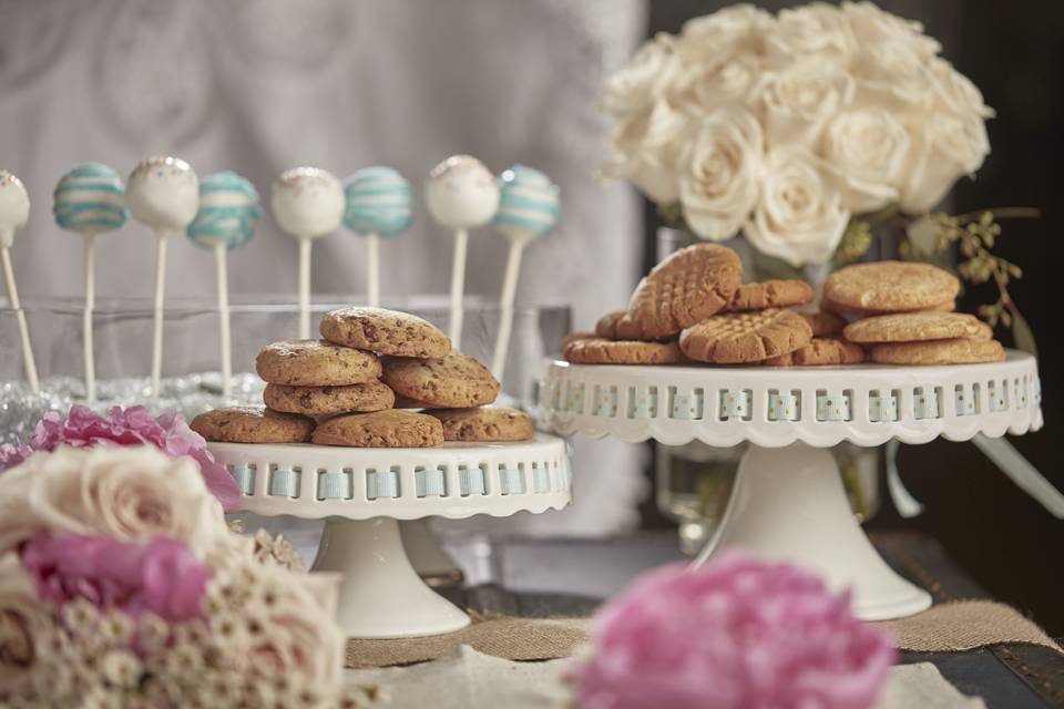 Dessert Bar with Gluten Free Cookies, CakePops and multiple floral arrangements.
