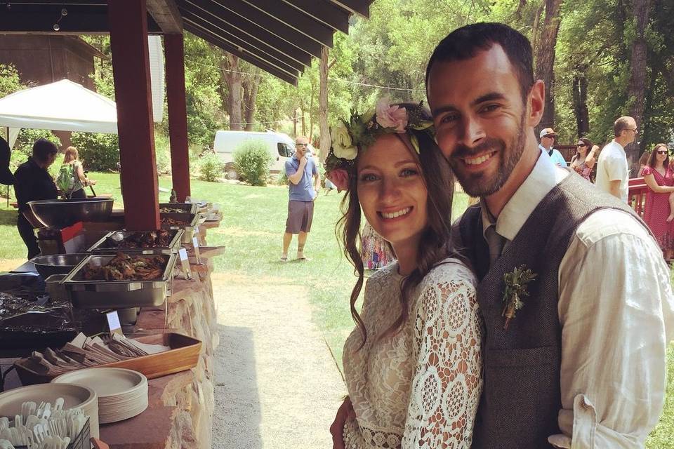 Newlyweds by the catering display