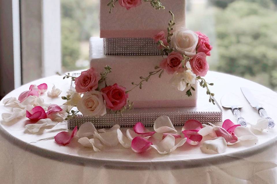 Beautiful cake docrated with gorgeous blush, pink and white flowers.