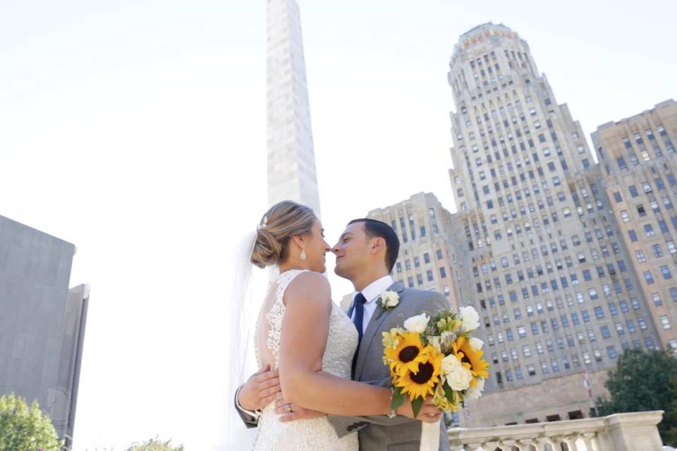 A couple standing in a cityscape